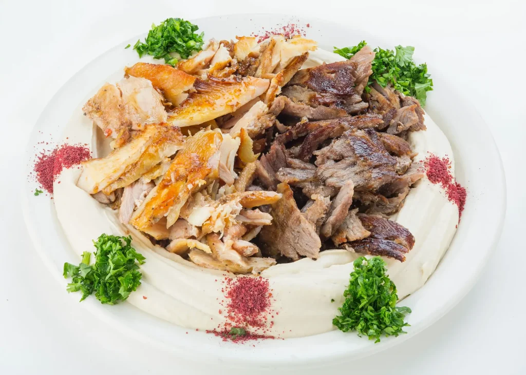 Mixed chicken and beef platter on a white plate
