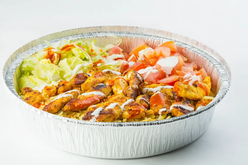 Chicken and rice platter with salad and sauce
